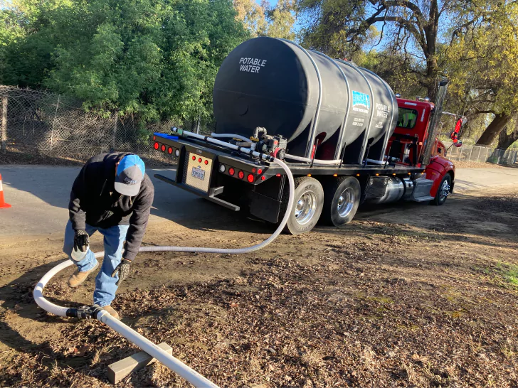 Jorge Aguilar of Self Help Enterprises delivering water in Visalia, CA.